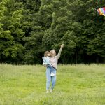youngster-outdoors-mom-playing-with-kite